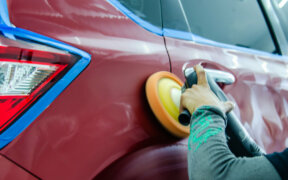 waxing a car with an orbital buffer