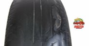 old car tire with unevenly worn tread that is dangerous to drive with