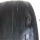 old car tire with unevenly worn tread that is dangerous to drive with