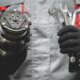 auto mechanic with ac compressor and tools